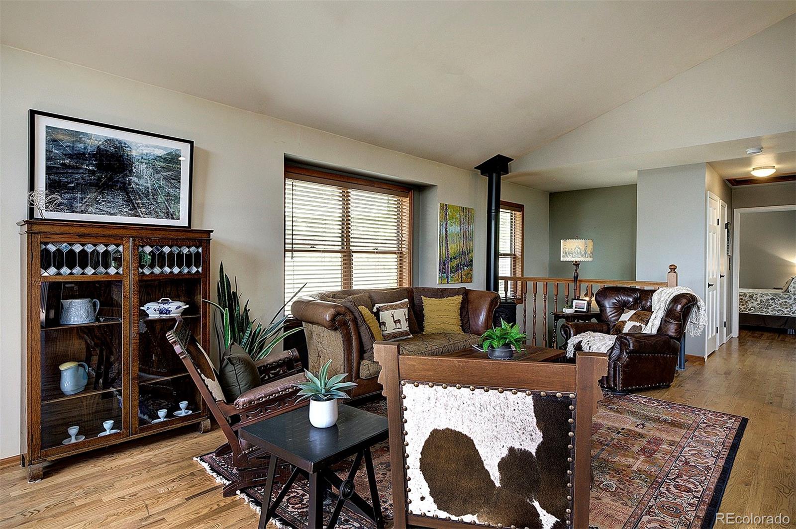 29659 Spruce Road Evergreen, CO 80439 - Photo 7 of 38 a living room with furniture and a bookshelf