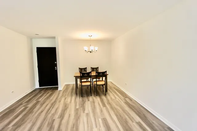 a dining room with furniture and wooden floor