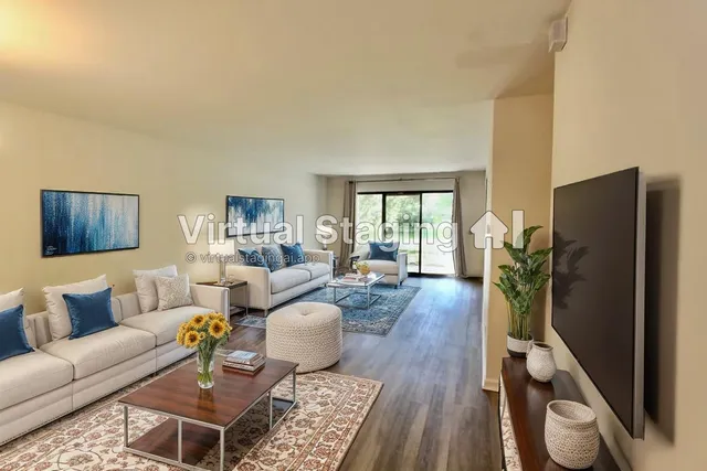 a living room with furniture a wooden floor and a large window