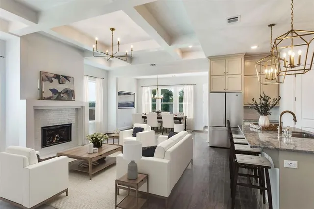 a living room with furniture a chandelier and a fireplace