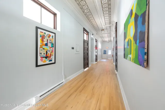 a view of entryway and hall with wooden floor