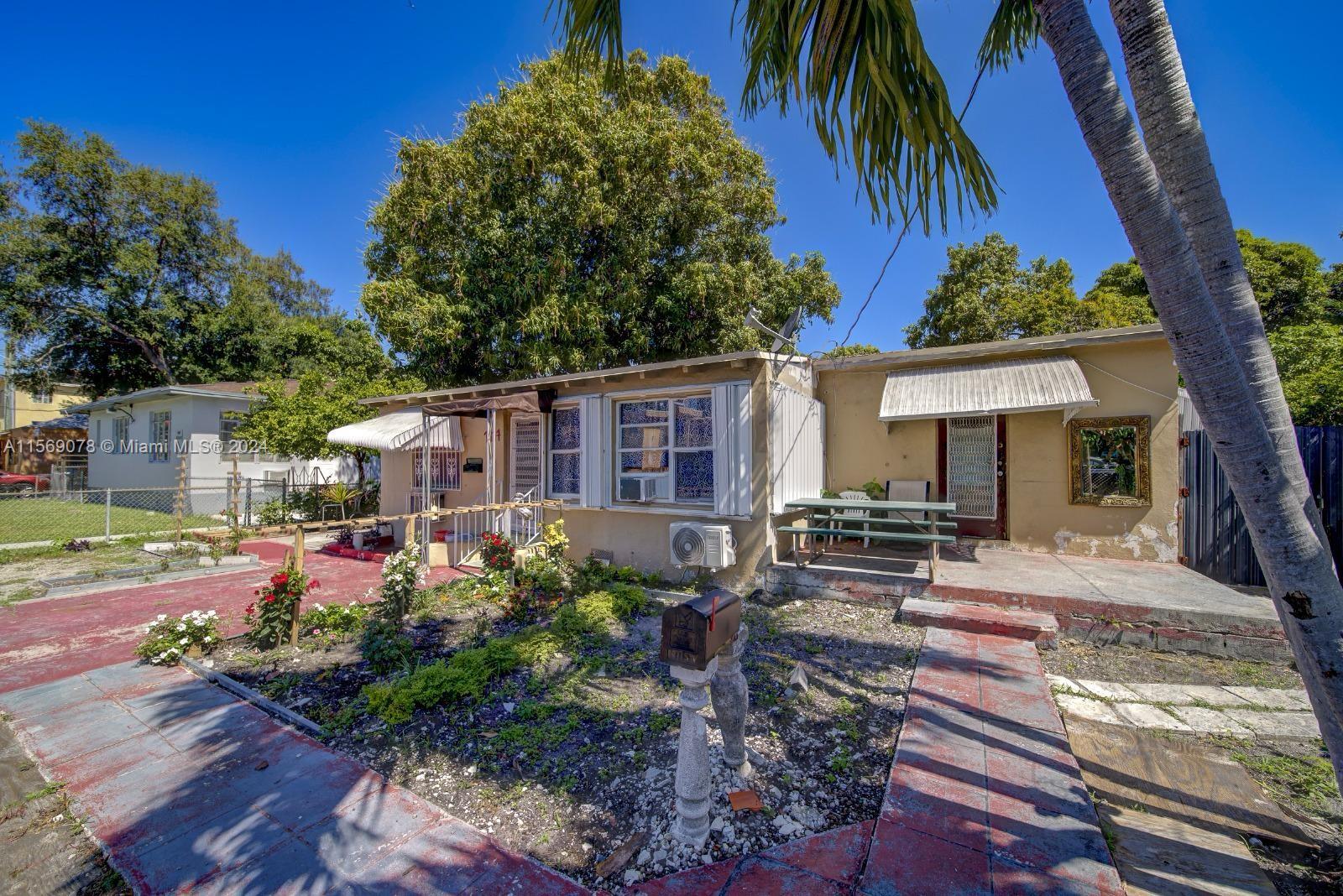 1877 Southwest 6th Street Miami, FL 33135 - Photo 1 of 12 a front view of a house with garden