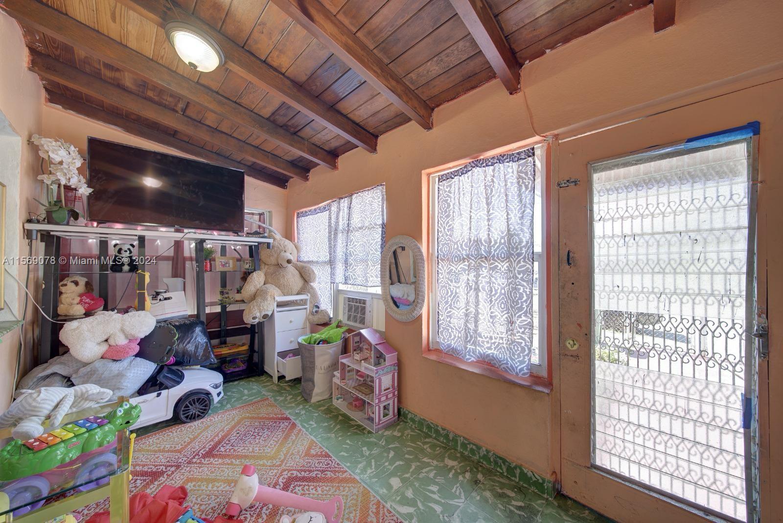 1877 Southwest 6th Street Miami, FL 33135 - Photo 2 of 12 a bedroom with furniture and a window
