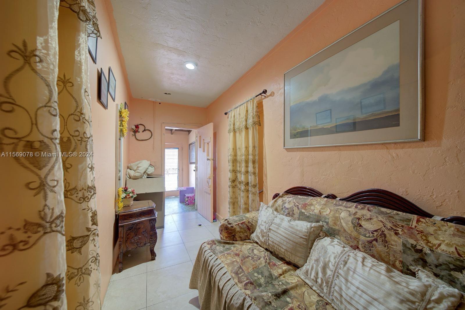 1877 Southwest 6th Street Miami, FL 33135 - Photo 5 of 12 a bedroom with a bed and a painting on the wall