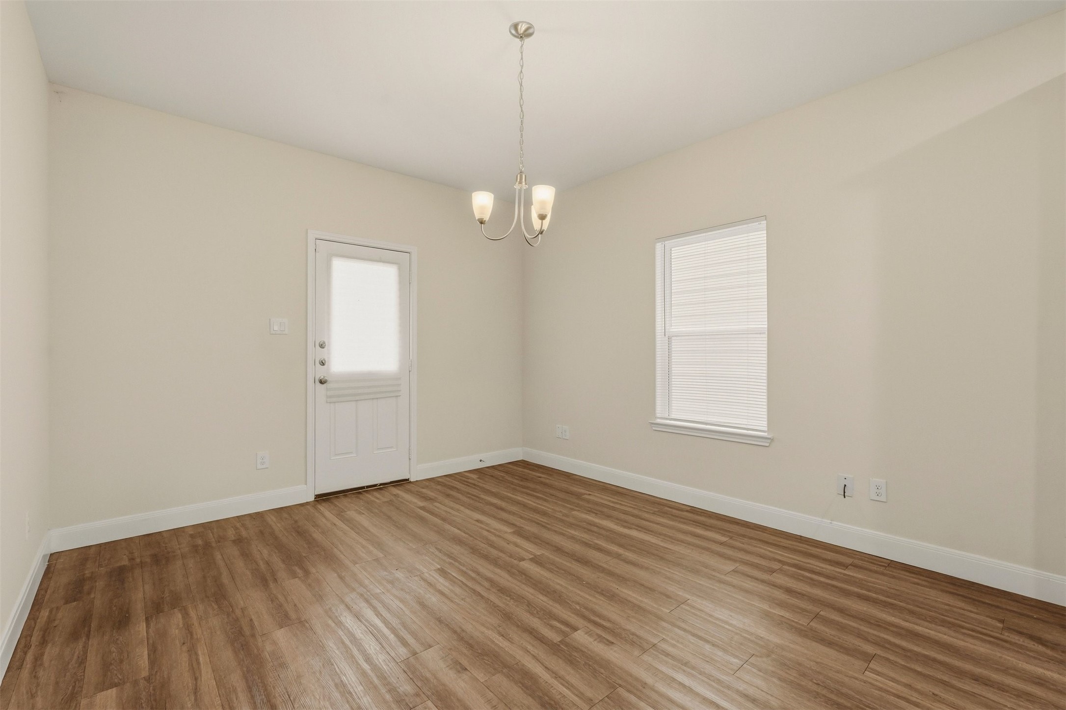 2218 Bringhurst Street, Unit B Houston, TX 77026 - Photo 12 of 25 wooden floor in an empty room with a window