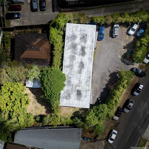 an aerial view of a house with a yard