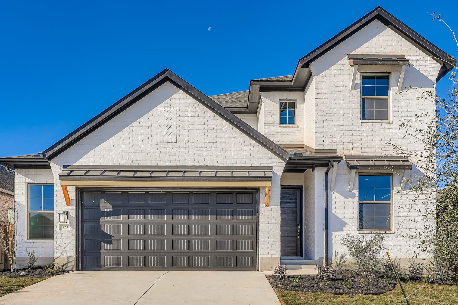 a front view of a house with garage