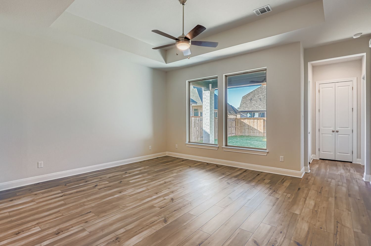 121 Prickly Poppy Loop Kyle, TX 78640 - Photo 2 of 8 wooden floor in an empty room with a window