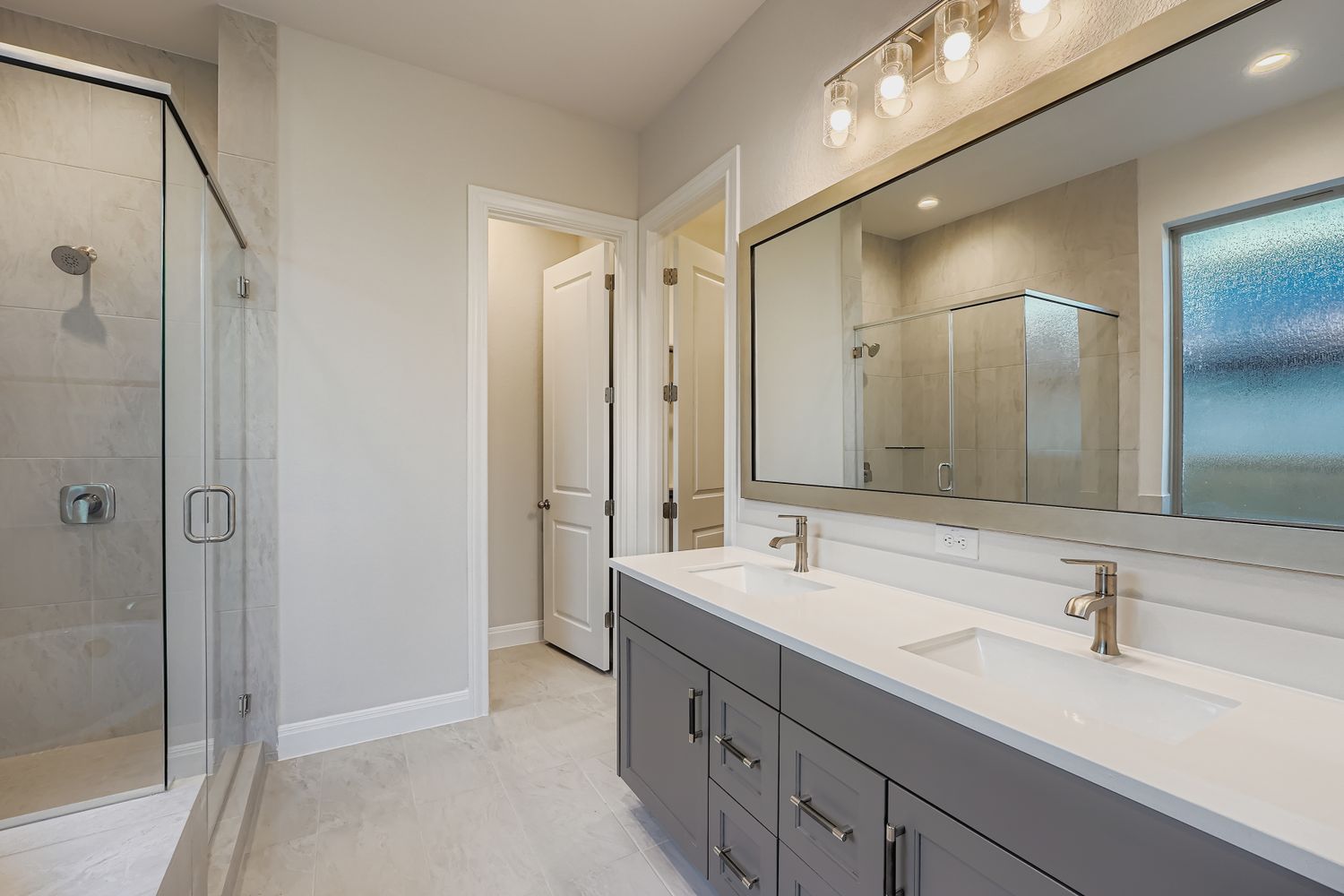 121 Prickly Poppy Loop Kyle, TX 78640 - Photo 5 of 8 a bathroom with a double vanity sink mirror and double