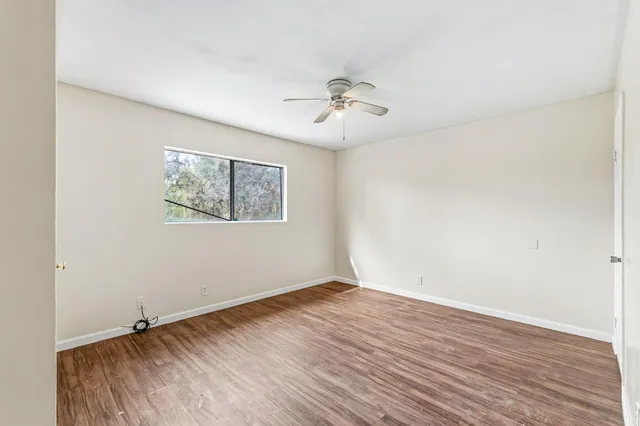 wooden floor in an empty room with a window