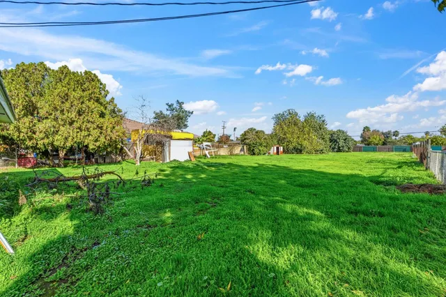 a view of a garden with a building in the background