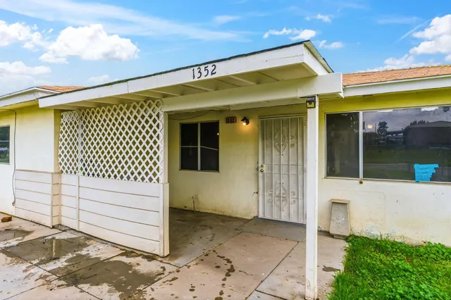 a view of a house with a wooden fence