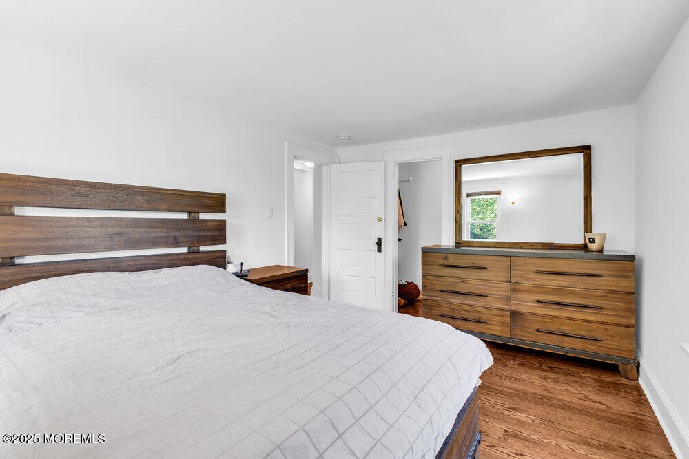 208 East Bergen Place Red Bank, NJ 07701 - Photo 12 of 25 a bedroom with a bed and a dresser