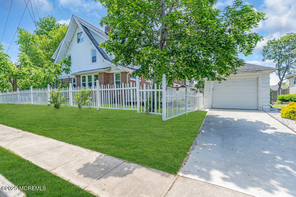 208 East Bergen Place Red Bank, NJ 07701 - Photo 2 of 25 a front view of a house with a garden and yard