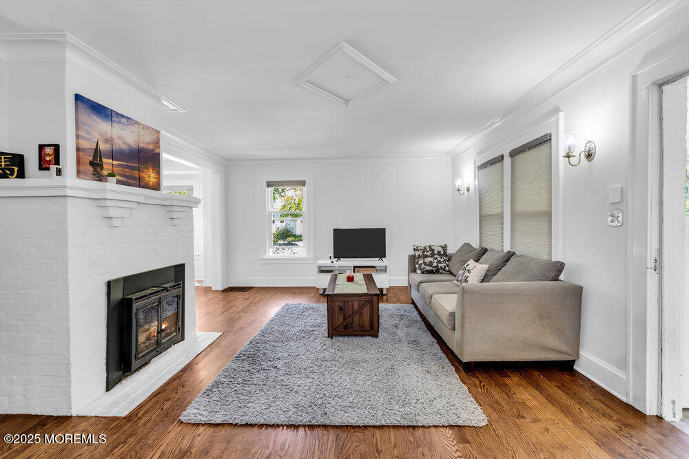208 East Bergen Place Red Bank, NJ 07701 - Photo 4 of 25 a living room with furniture and a fireplace