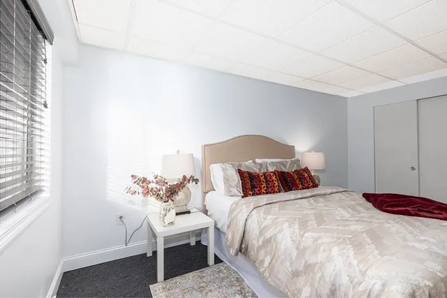 a bedroom with a bed and a chair