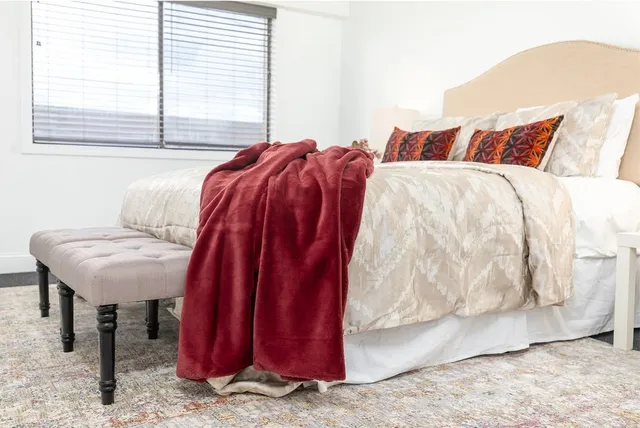 a view of a bedroom with a bed and a window