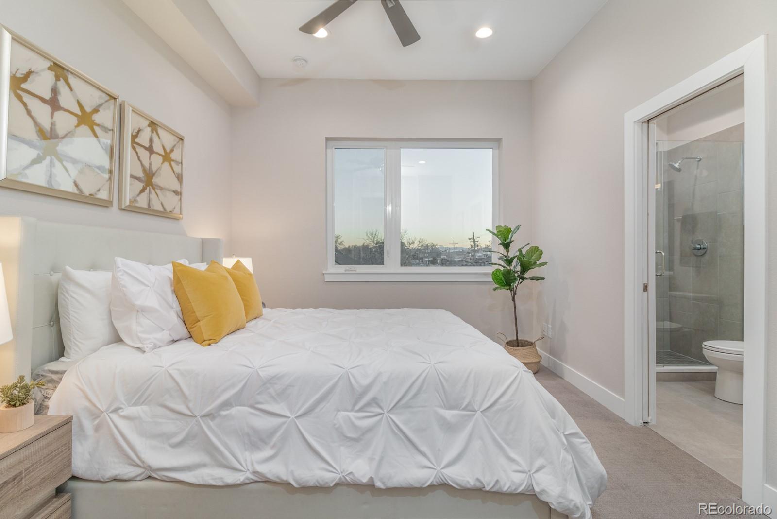 927 Inca Street, Unit 3 Denver, CO 80204 - Photo 13 of 24 a bedroom with a bed and painting on the wall
