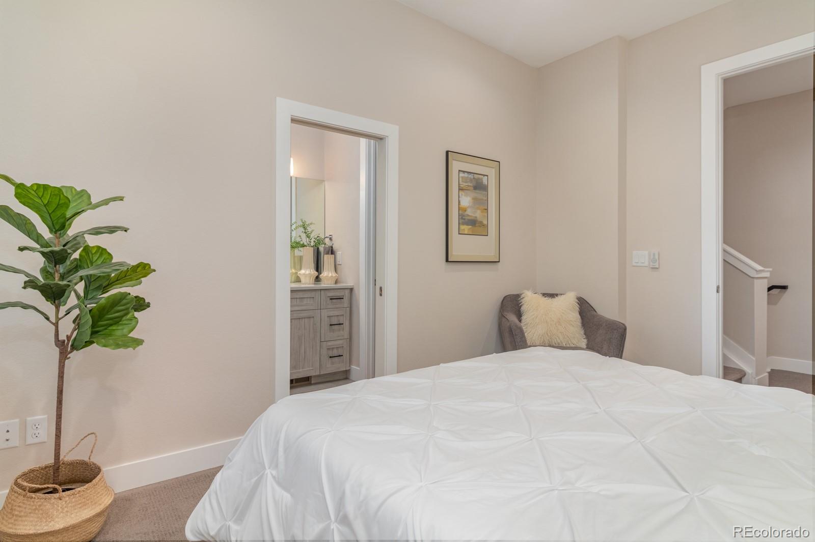 927 Inca Street, Unit 3 Denver, CO 80204 - Photo 15 of 24 a bedroom with a bed and a potted plant