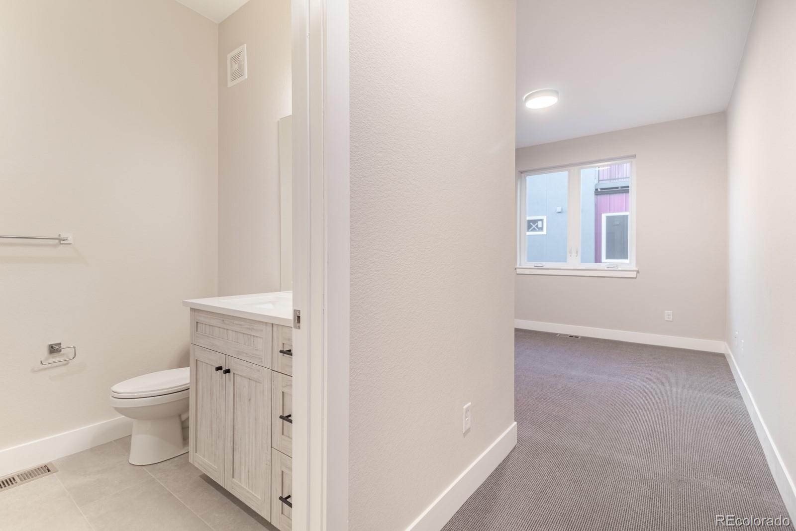 927 Inca Street, Unit 3 Denver, CO 80204 - Photo 17 of 24 a very nice looking room with a chair and a toilet