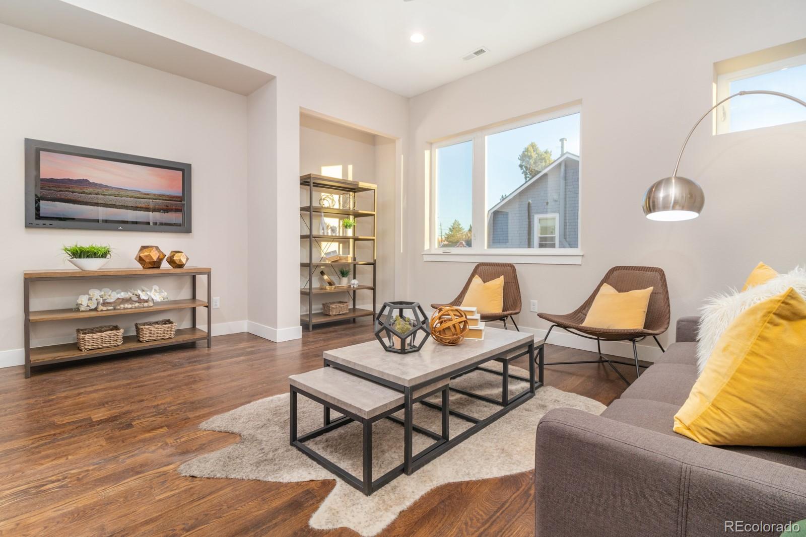 927 Inca Street, Unit 3 Denver, CO 80204 - Photo 5 of 24 a living room with furniture and wooden floor