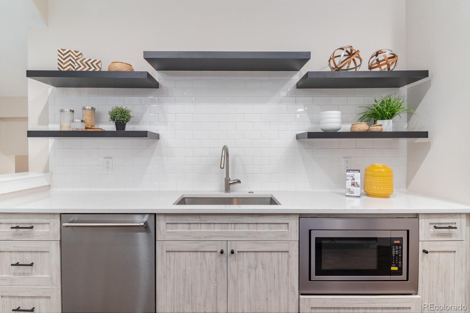 927 Inca Street, Unit 3 Denver, CO 80204 - Photo 9 of 24 a kitchen with a stove and cabinets
