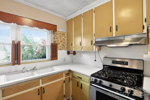 a kitchen with stainless steel appliances granite countertop a stove and a refrigerator