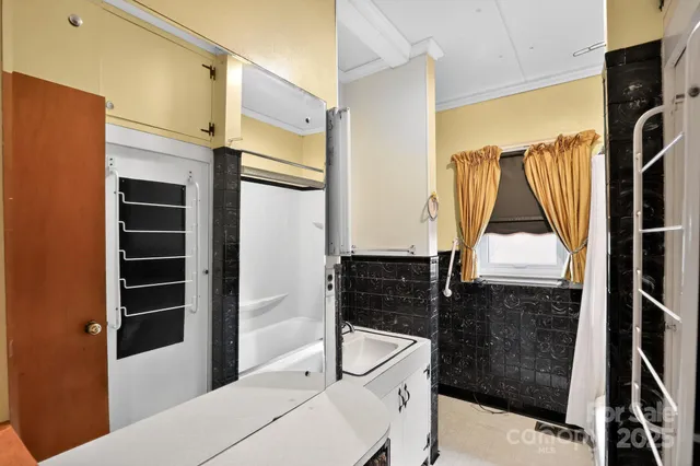 a bathroom with a bathtub and a shower