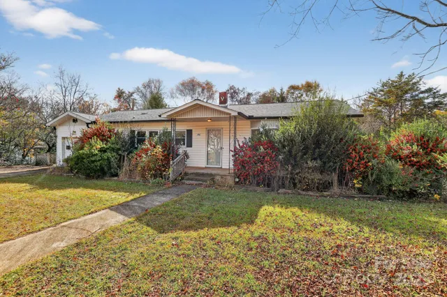 a view of a house with a garden and a yard