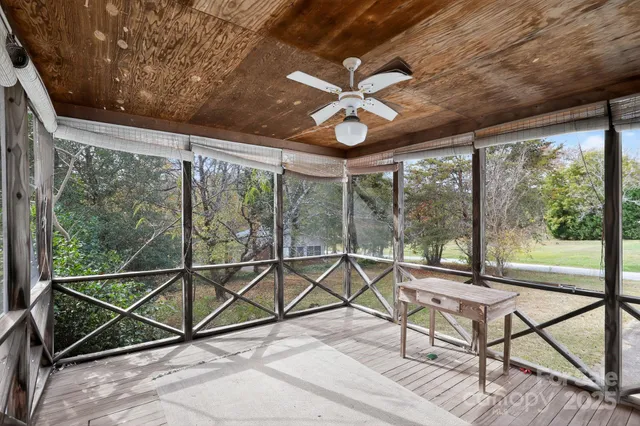 a view of a house with a yard and sitting area