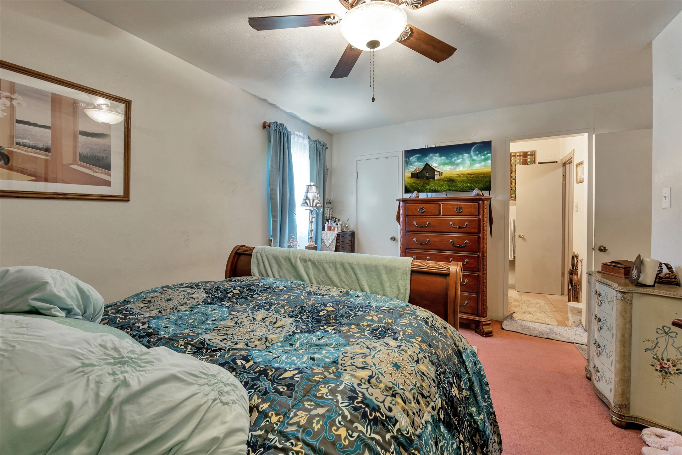 2913 18th Avenue North Texas City, TX 77590 - Photo 23 of 42 a bedroom with a bed and a chandelier