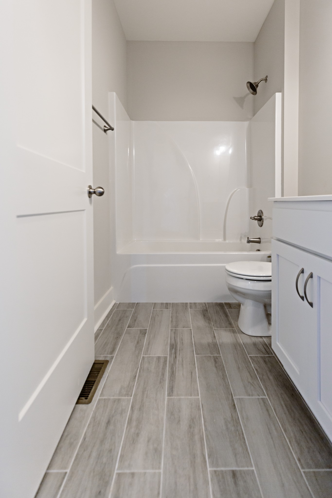 246 Woodruff Road Adams, TN 37010 - Photo 18 of 18 a bathroom with a white tub shower vanity and a toilet