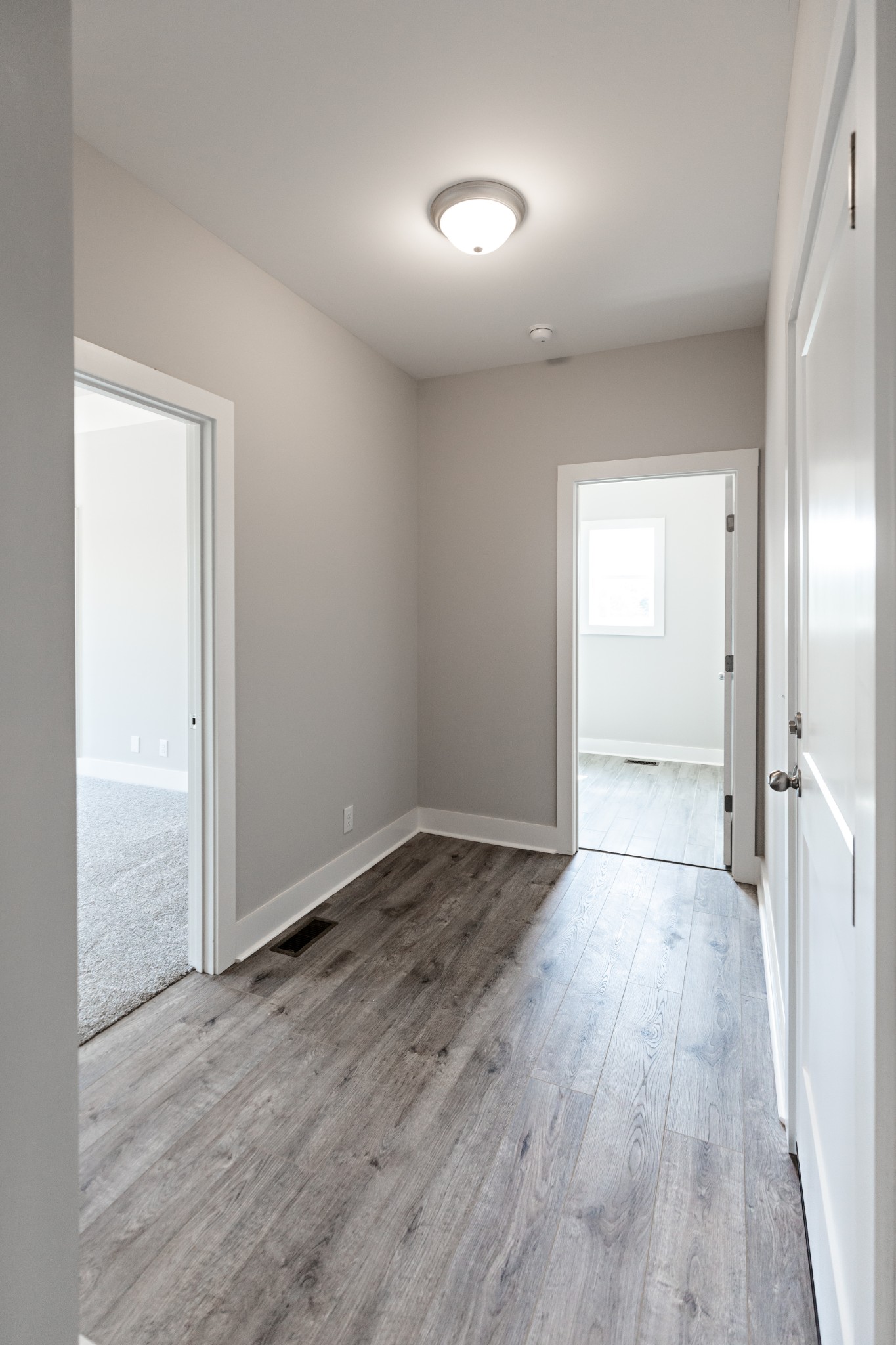 246 Woodruff Road Adams, TN 37010 - Photo 9 of 18 an empty room with wooden floor and windows