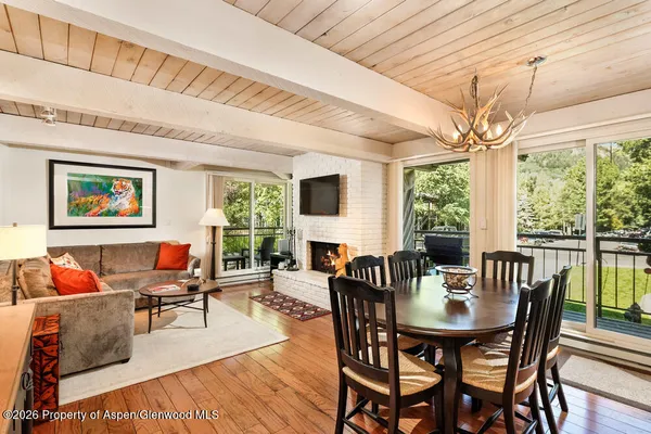 a living room with furniture a table and a large window