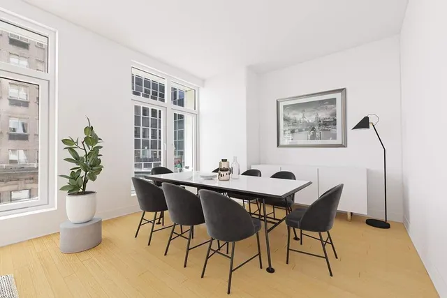 a living room with furniture and large windows