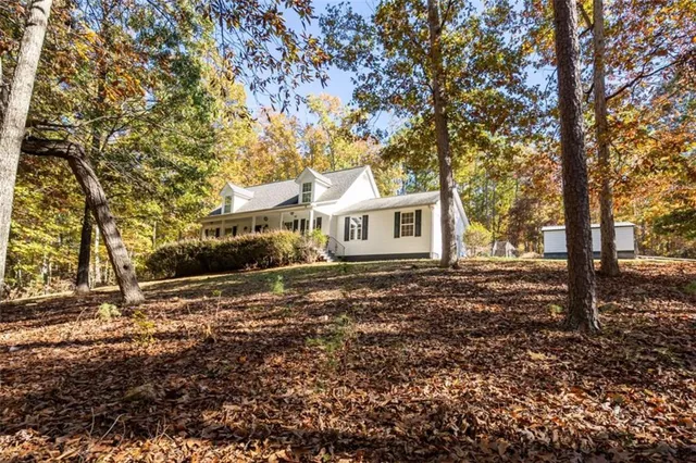 a backyard of a house with large trees and brick walls