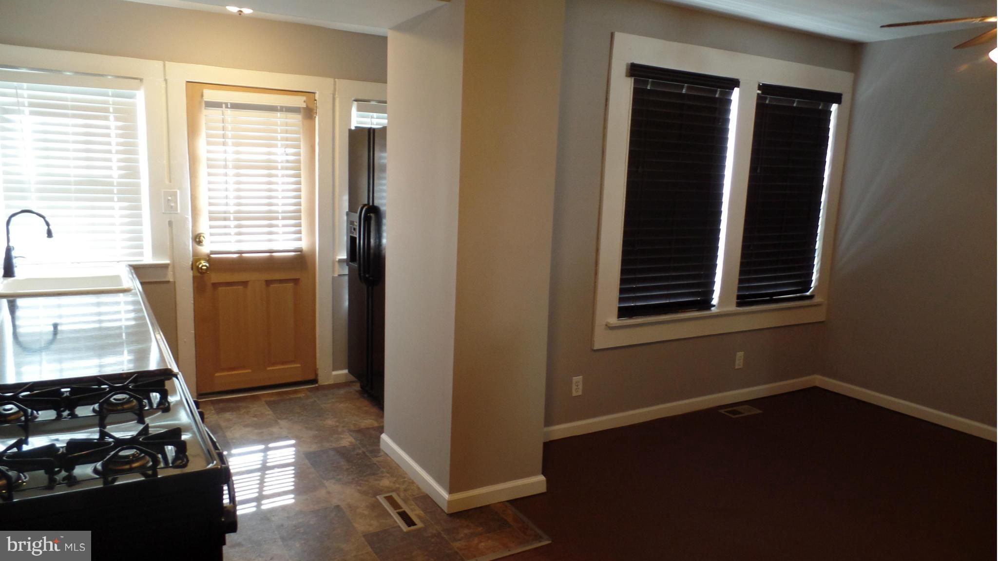 34 Portship Road Baltimore, MD 21222 - Photo 14 of 28 an empty room with wooden floor windows and cabinet