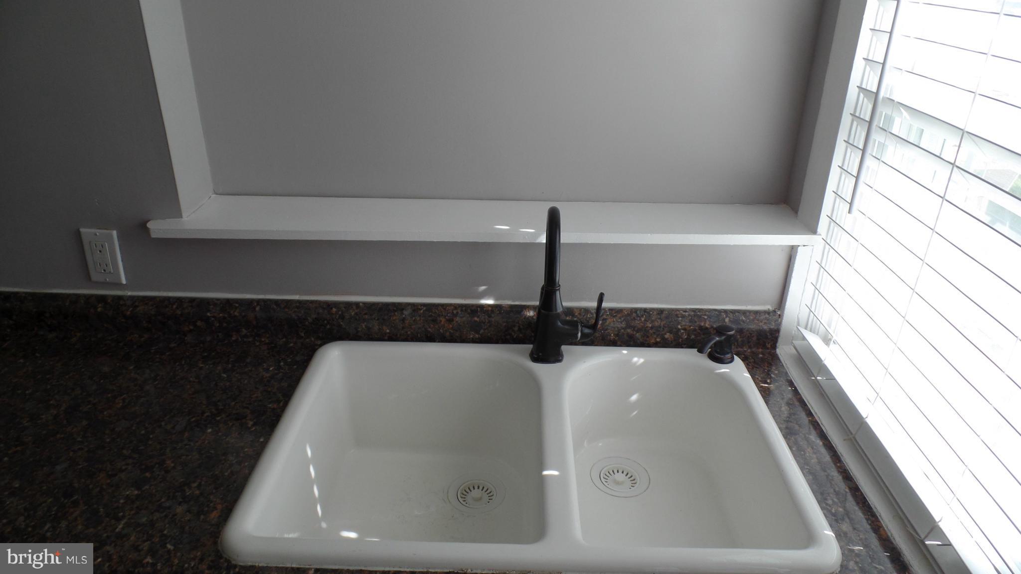 34 Portship Road Baltimore, MD 21222 - Photo 16 of 28 a bathroom with a sink and mirror