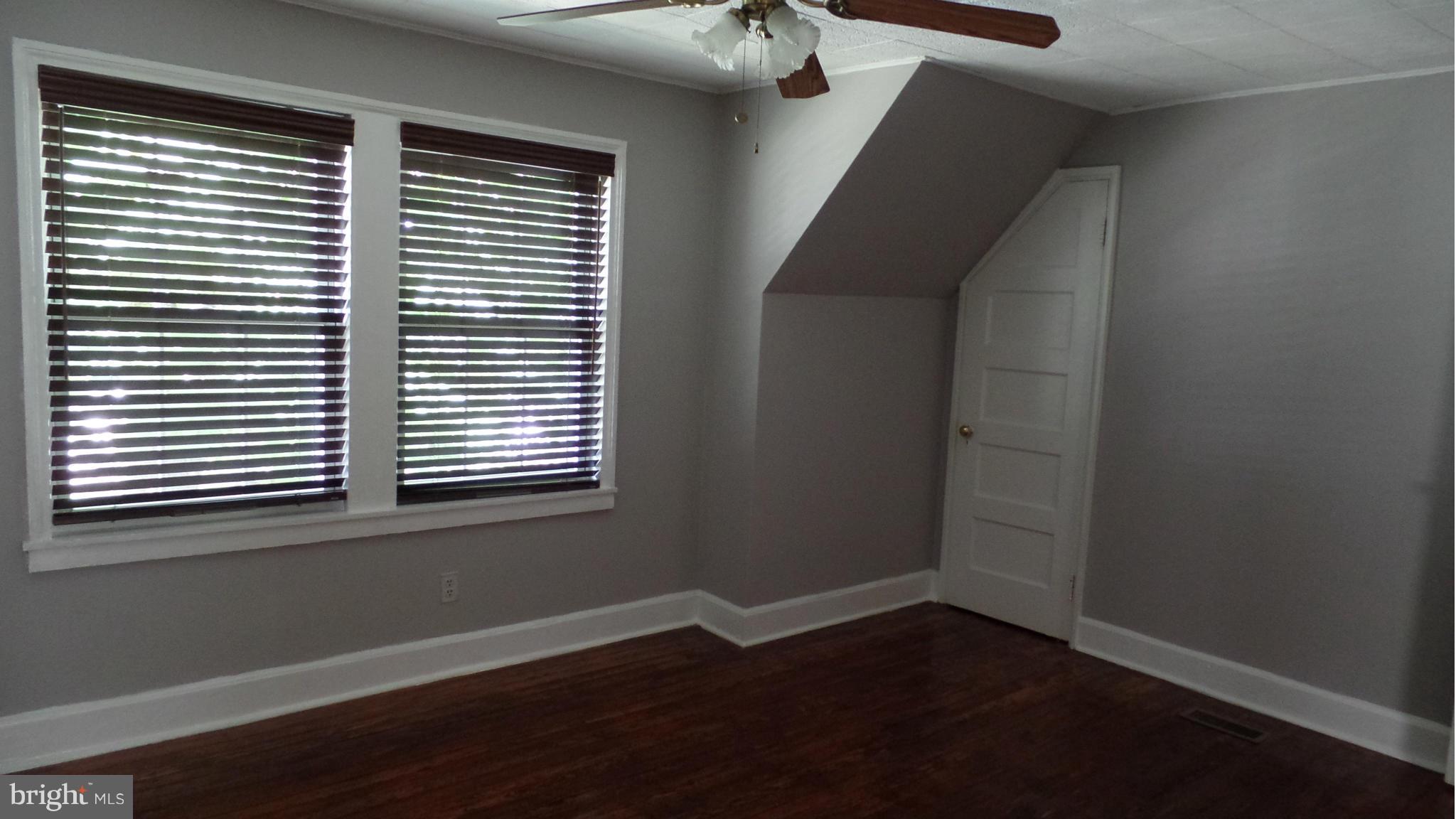 34 Portship Road Baltimore, MD 21222 - Photo 17 of 28 wooden floor in an empty room with a window