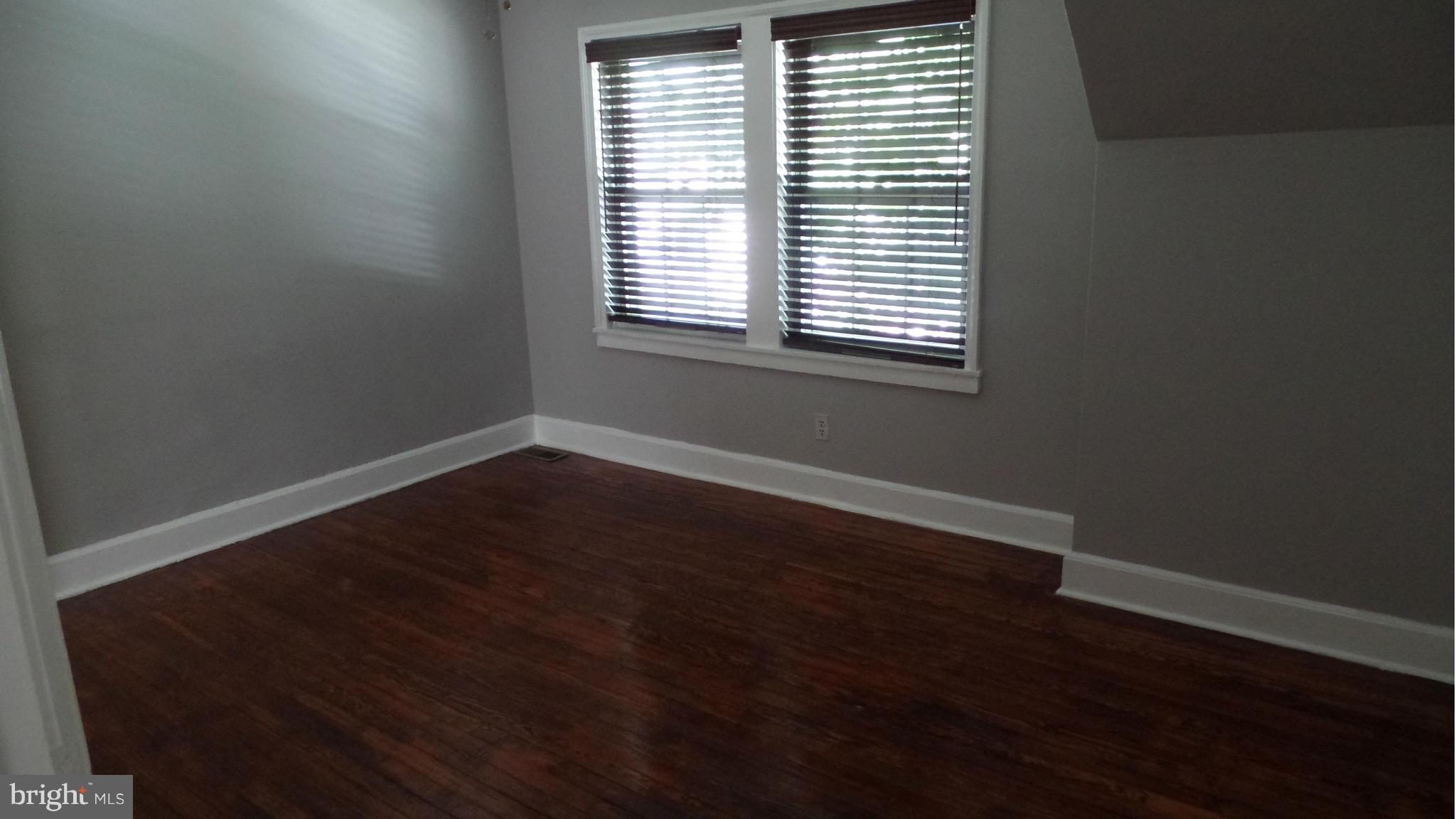 34 Portship Road Baltimore, MD 21222 - Photo 18 of 28 an empty room with wooden floor and a window