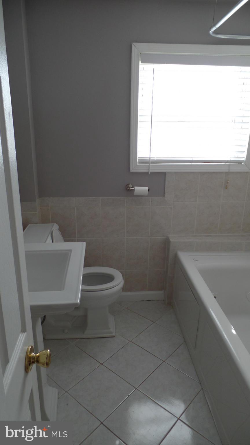 34 Portship Road Baltimore, MD 21222 - Photo 21 of 28 a bathroom with a sink a toilet and tub