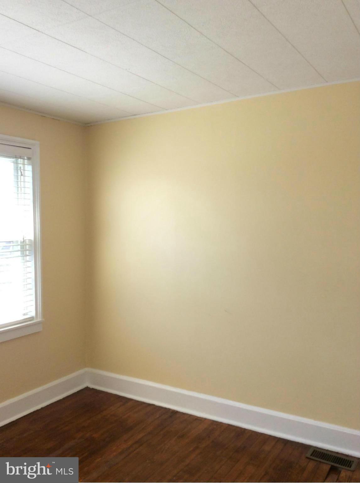 34 Portship Road Baltimore, MD 21222 - Photo 22 of 28 an empty room with a wooden floor and a window