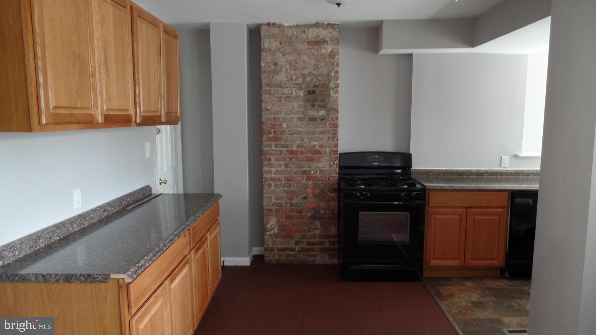 34 Portship Road Baltimore, MD 21222 - Photo 7 of 28 a kitchen with granite countertop a stove and a sink