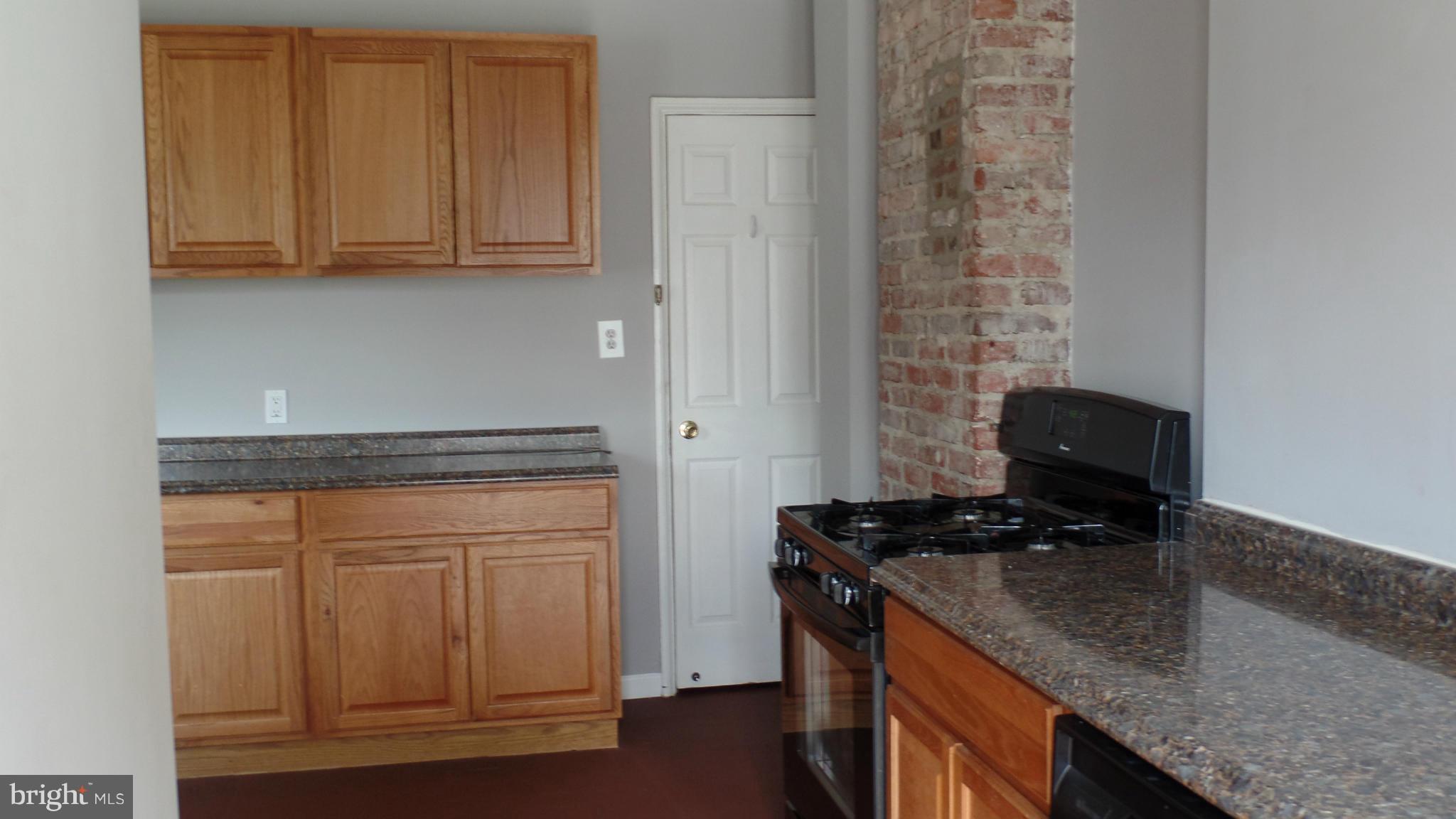 34 Portship Road Baltimore, MD 21222 - Photo 8 of 28 a kitchen with granite countertop cabinets stainless steel appliances and a counter space