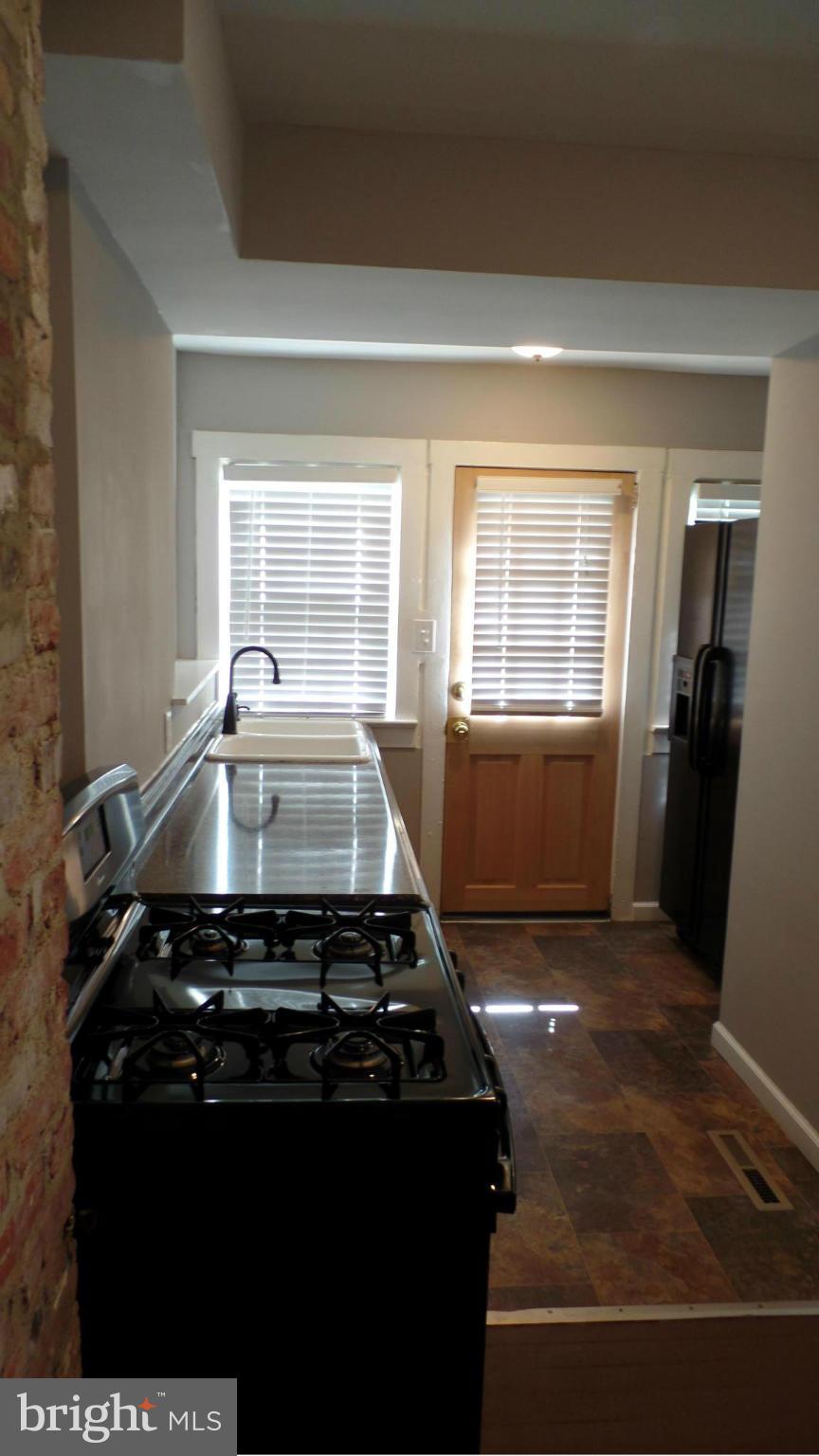 34 Portship Road Baltimore, MD 21222 - Photo 10 of 28 a kitchen with a stove and a refrigerator