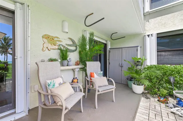 a view of a patio with a table and chairs under an umbrella
