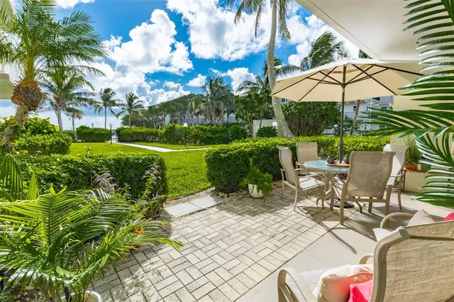 a building outdoor space with patio furniture and potted plants