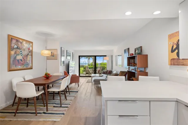 a kitchen with white cabinets stainless steel appliances and a sink