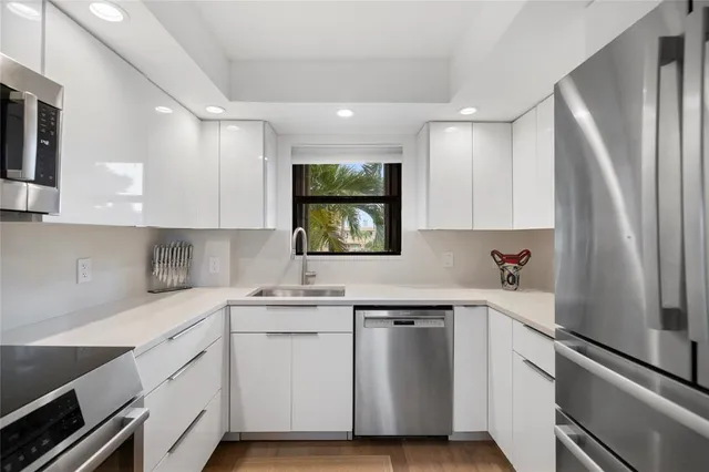 a kitchen with a sink stove and microwave