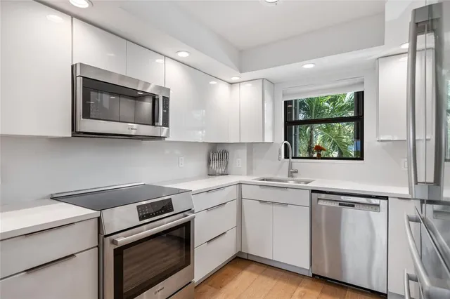 a kitchen with a sink cabinets and window